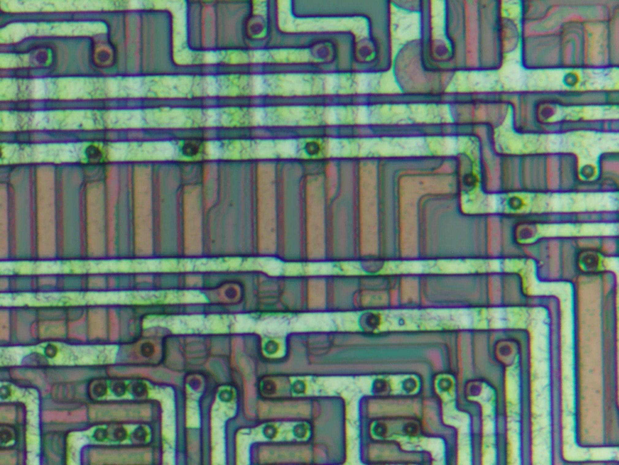 Image of metal getting etched away starting at vias (500x mag)